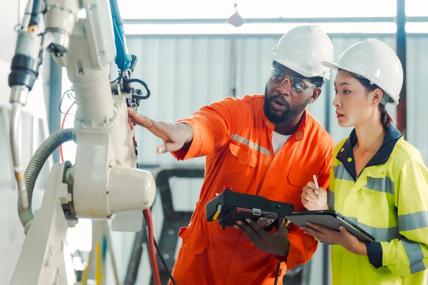 A man and woman in orange work clothes.