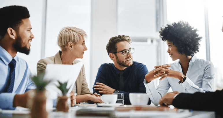A group of people sitting around a table.